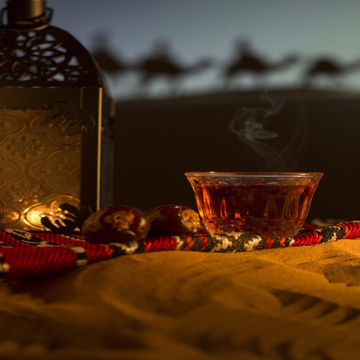 Arabic tea and dates in the desert at dusk