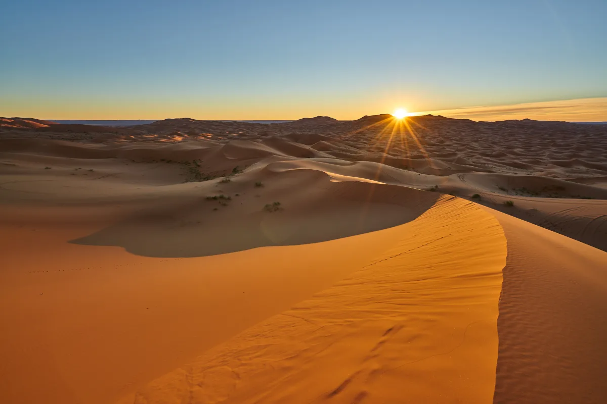 The sun setting over the tall dunes of the Liwa desert