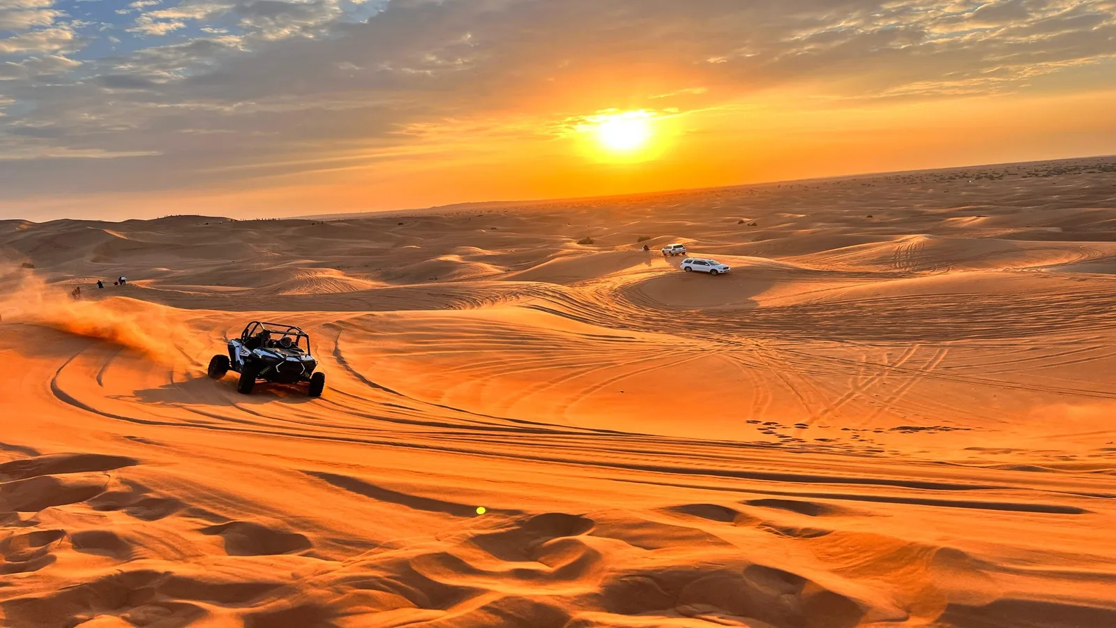 Quad bike rider exploring the golden dunes of the Arabian Desert during an Abu Dhabi desert tour