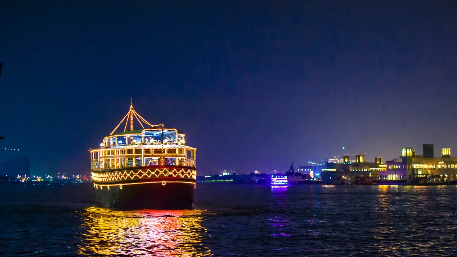 Traditional dhow cruise sailing along Abu Dhabi Corniche with the city skyline in the background
