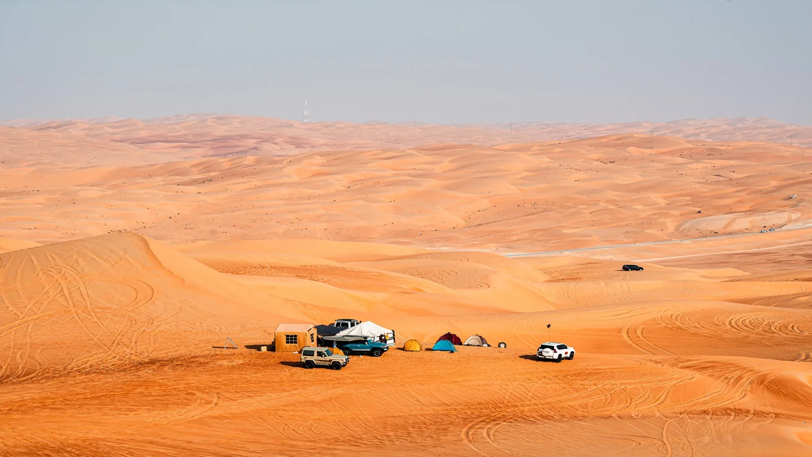 Comfortable overnight tents set up among the golden dunes of the Liwa Desert