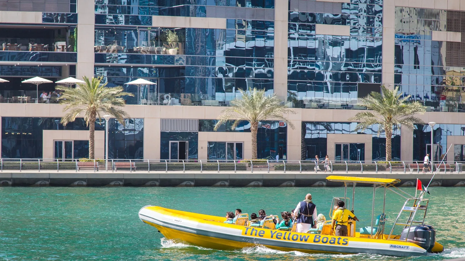 Yellow speedboat cruising along the Abu Dhabi coastline with stunning waterfront and skyline views