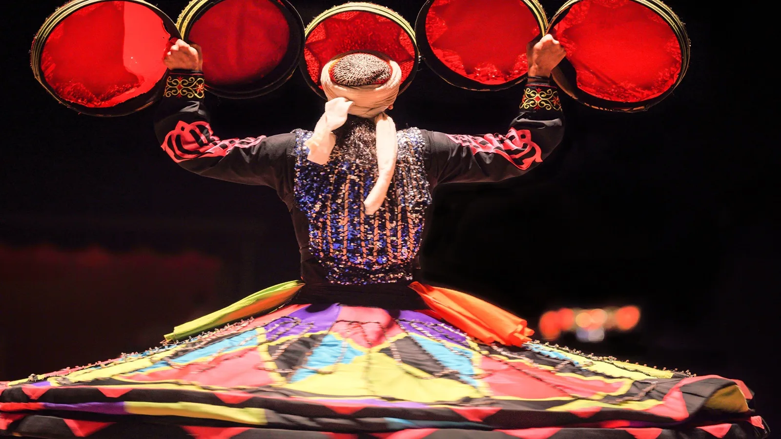 Tanoura dancer performing a traditional spinning dance during a Half Day Desert Safari in Abu Dhabi